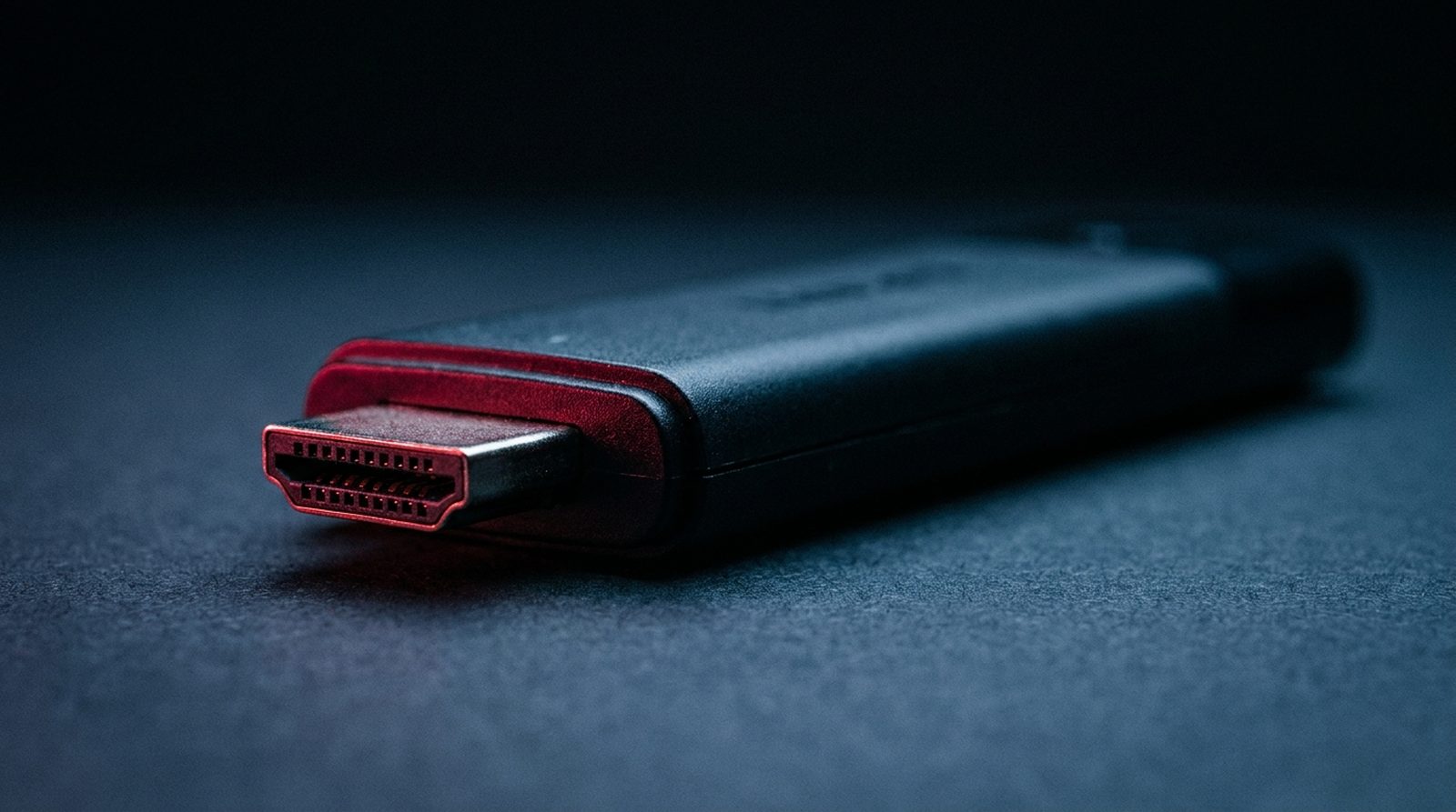 Best IPTV player apps for Firestick, shown as a streaming stick HDMI connector lit in red